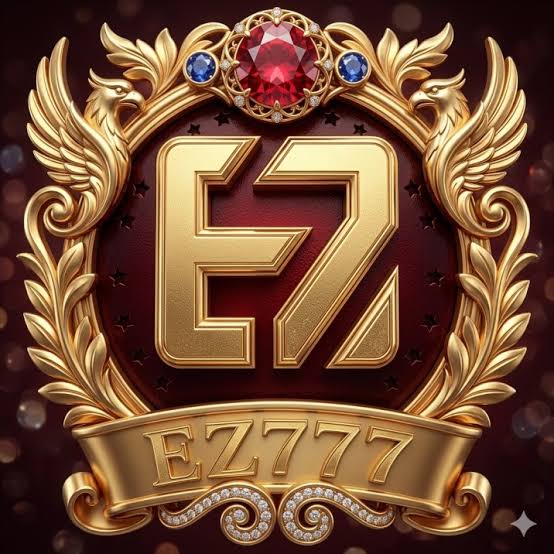 EZ777 Game logo featuring golden E7 lettering, a luxurious red gemstone, ornate gold wings, and a premium gaming emblem.